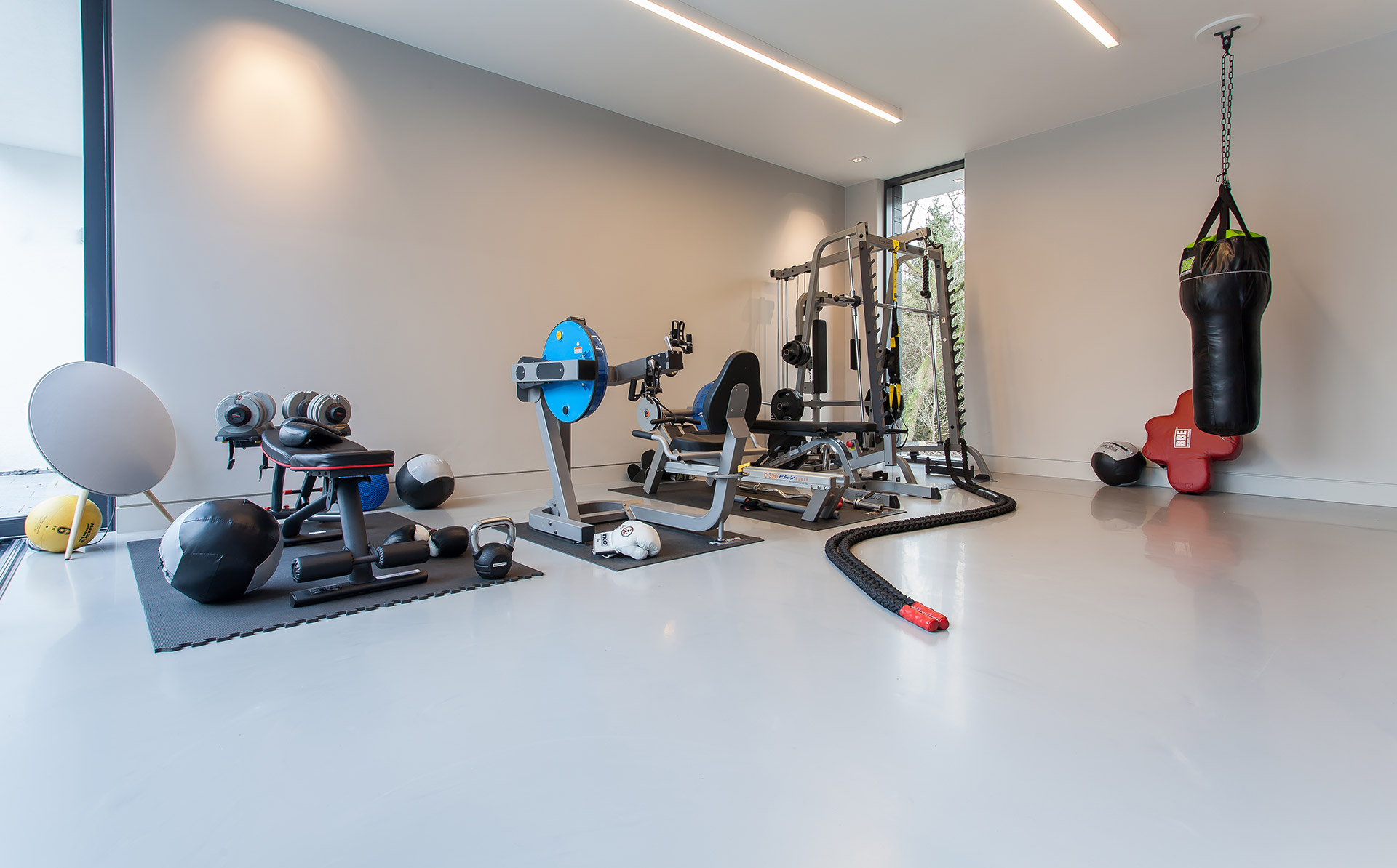 Grey residential resin floor in a home gym