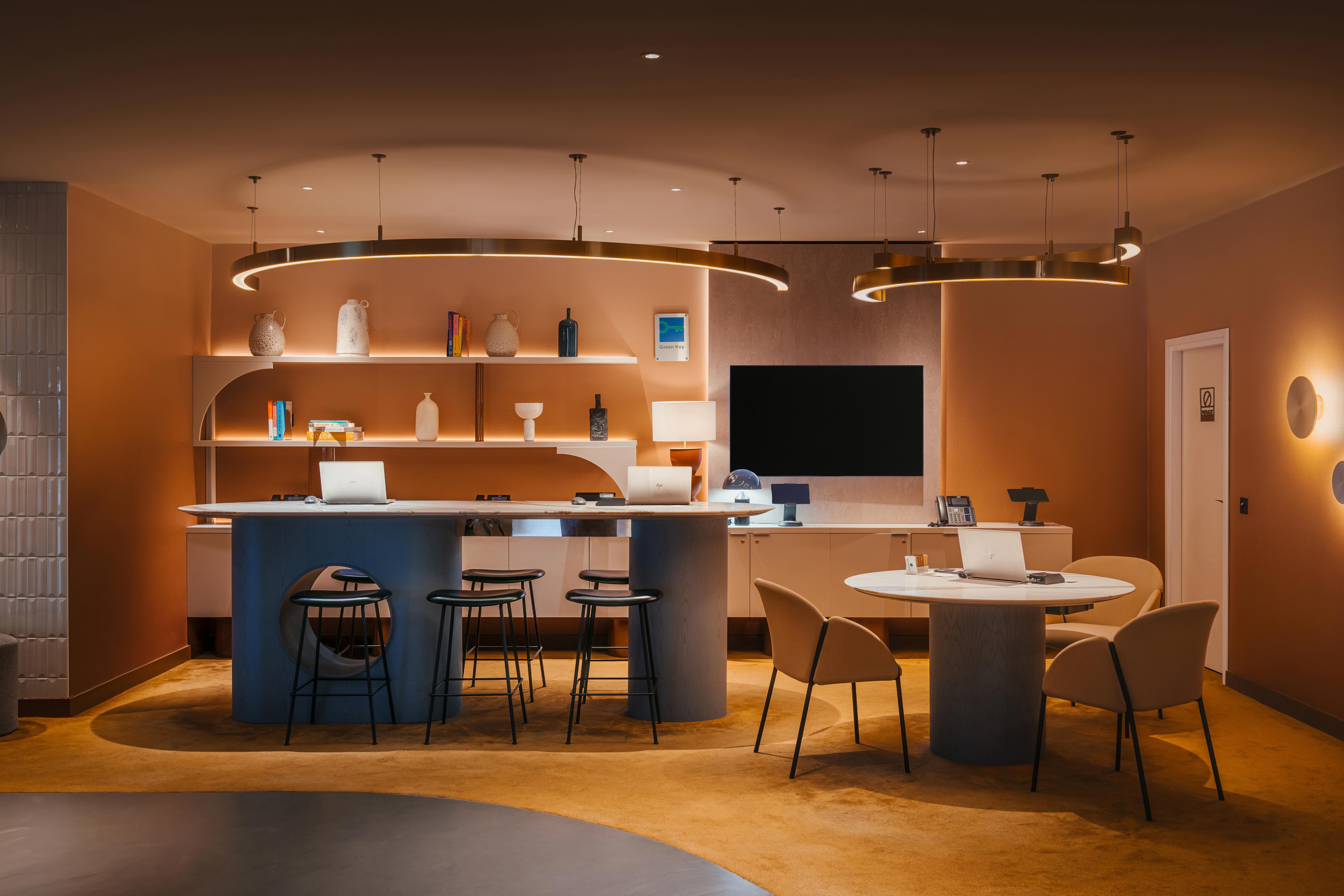 A reception desk with carpet and a seamless grey resin floor 
