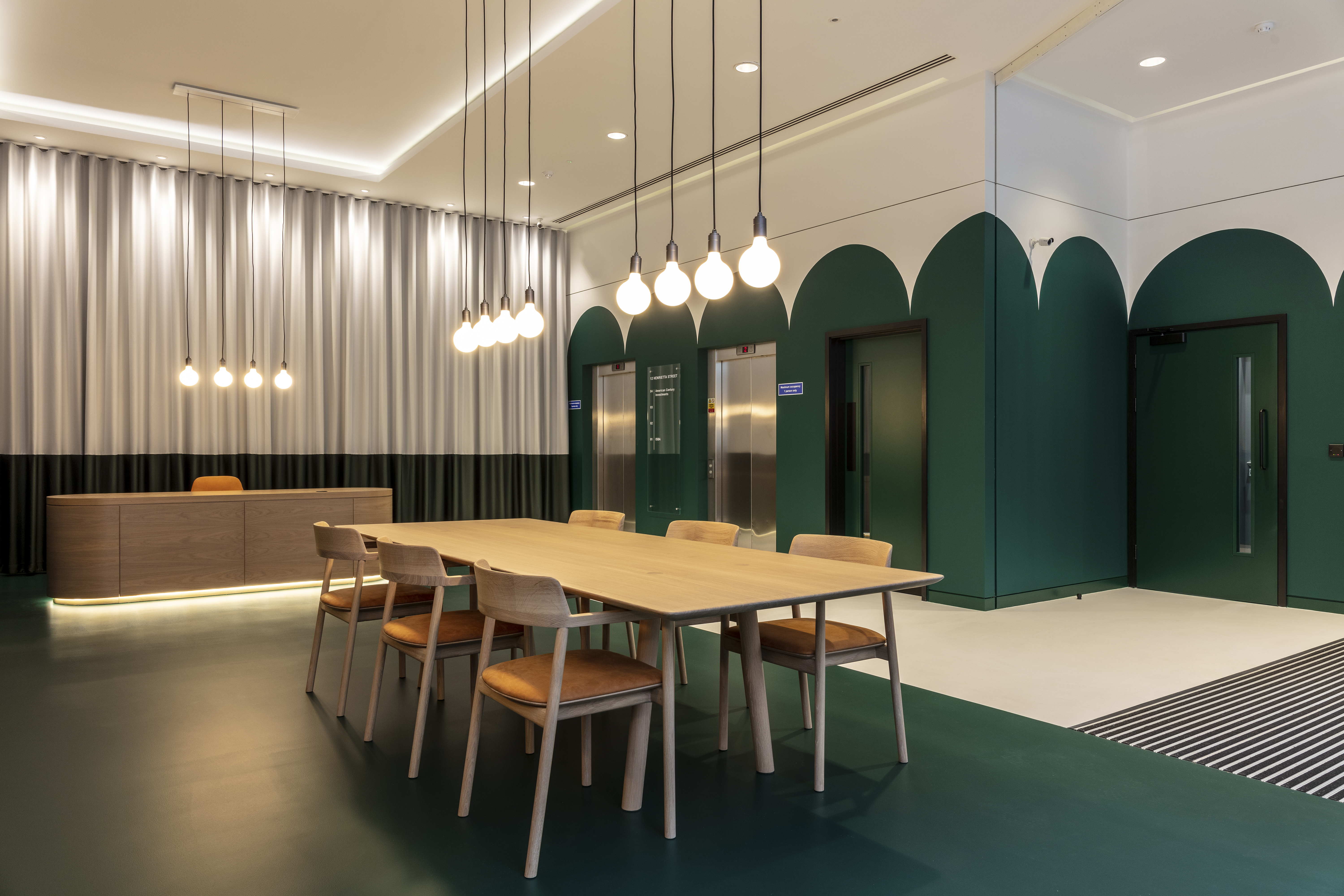 Green and white commercial resin flooring with a table and chairs in the middle of the room