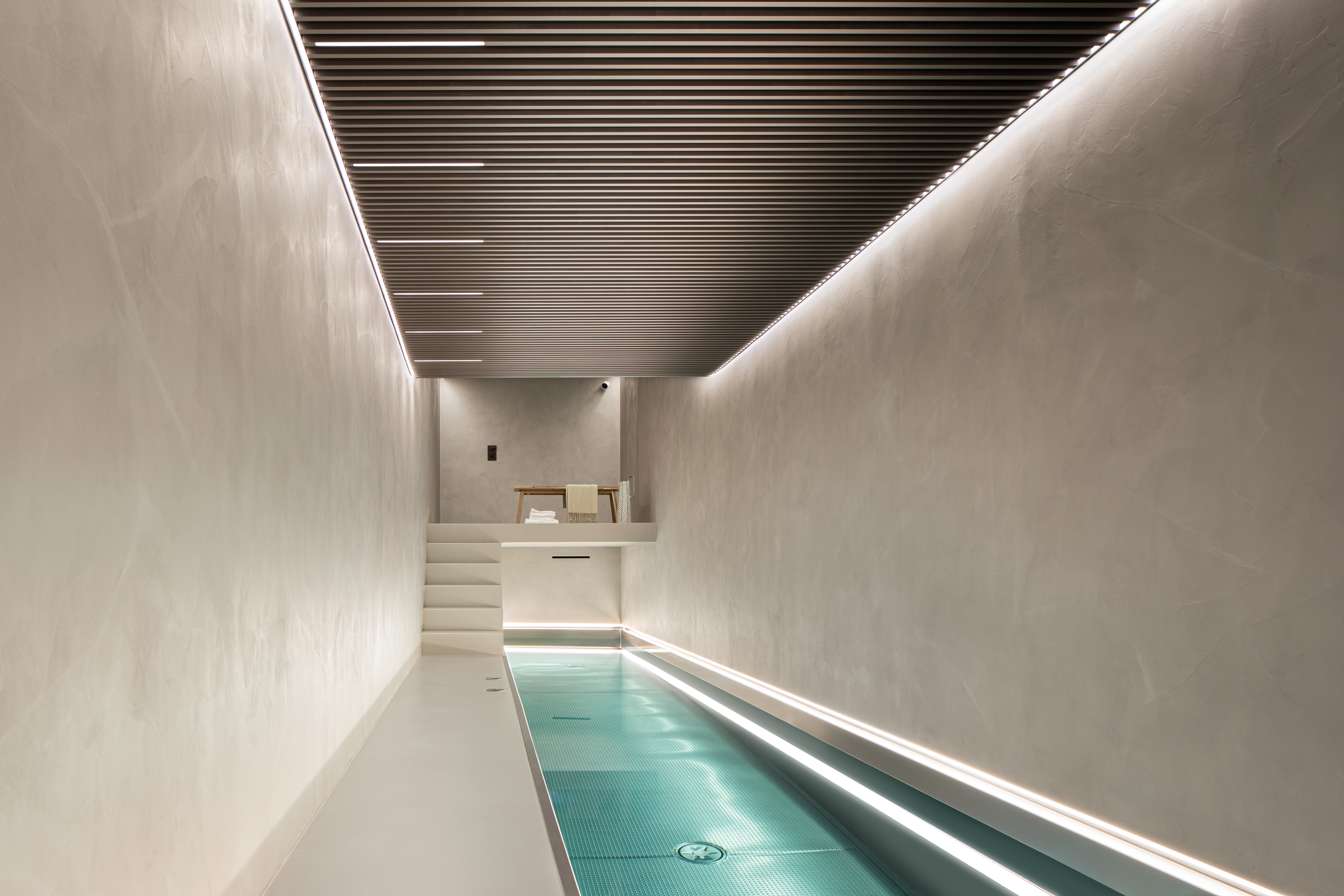 Warm grey resin floors and walls in a residential swimming pool