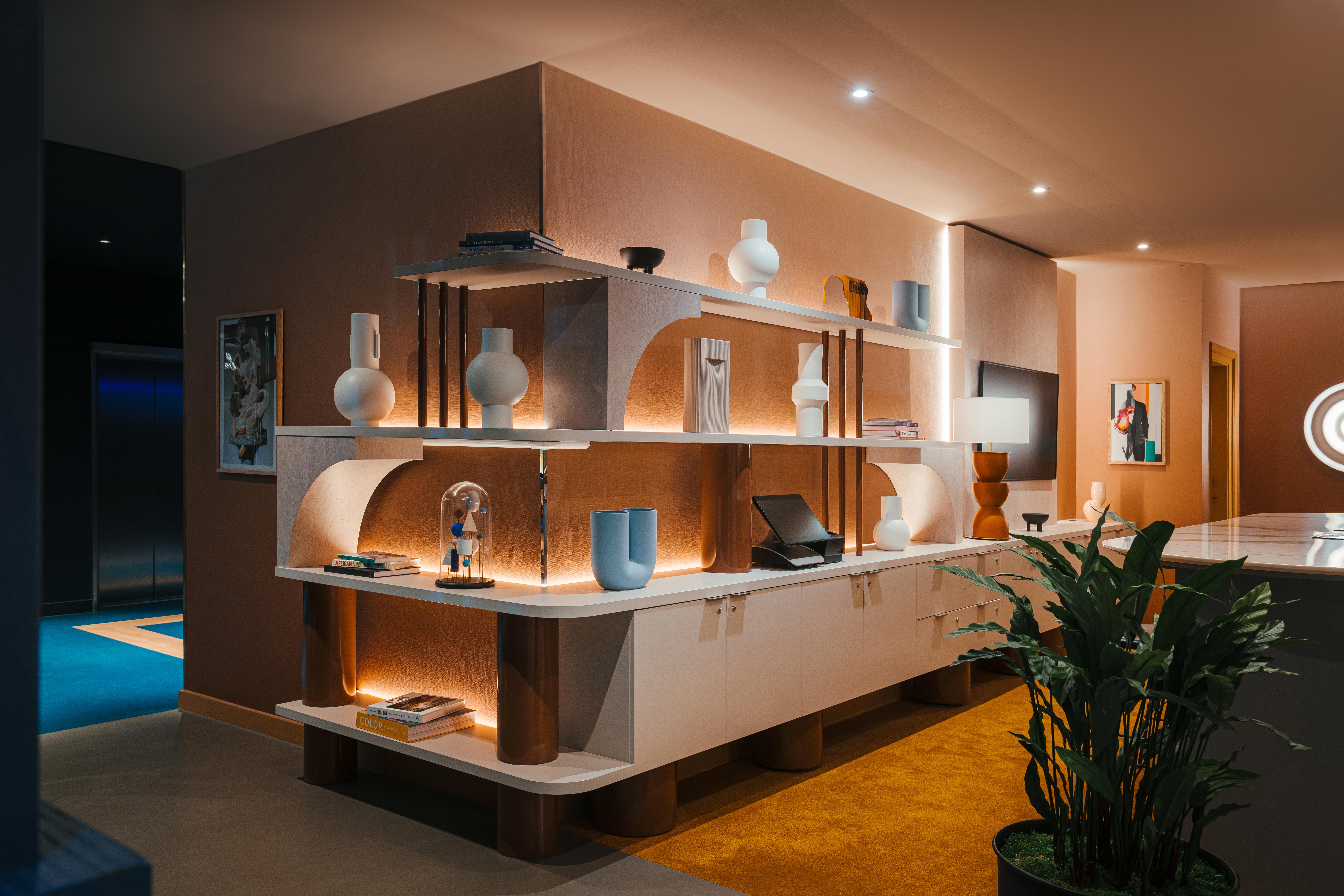 Hotel display shelf behind the reception desk, showing the blue and grey resin floors