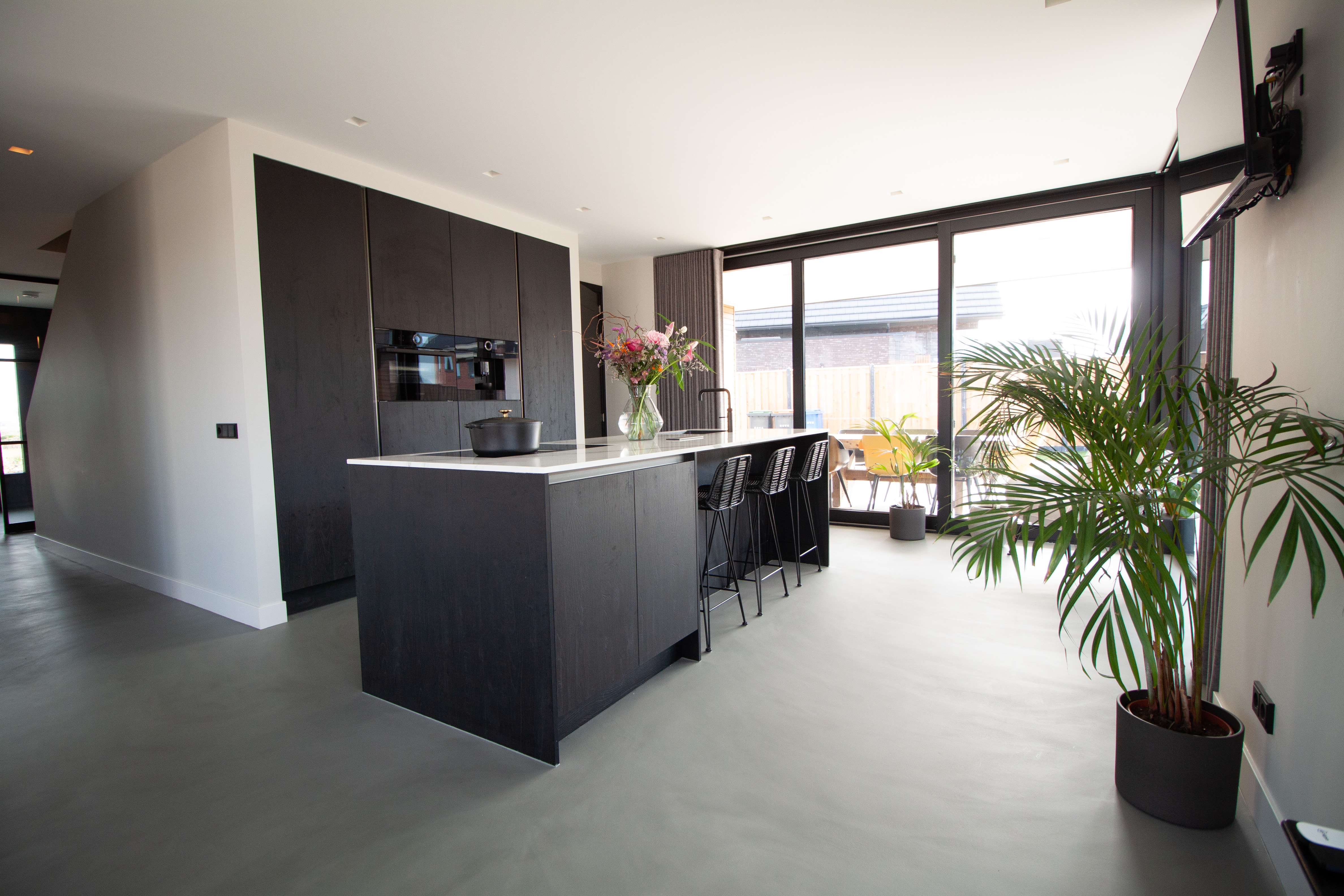Dark grey sustainable resin flooring in a kitchen