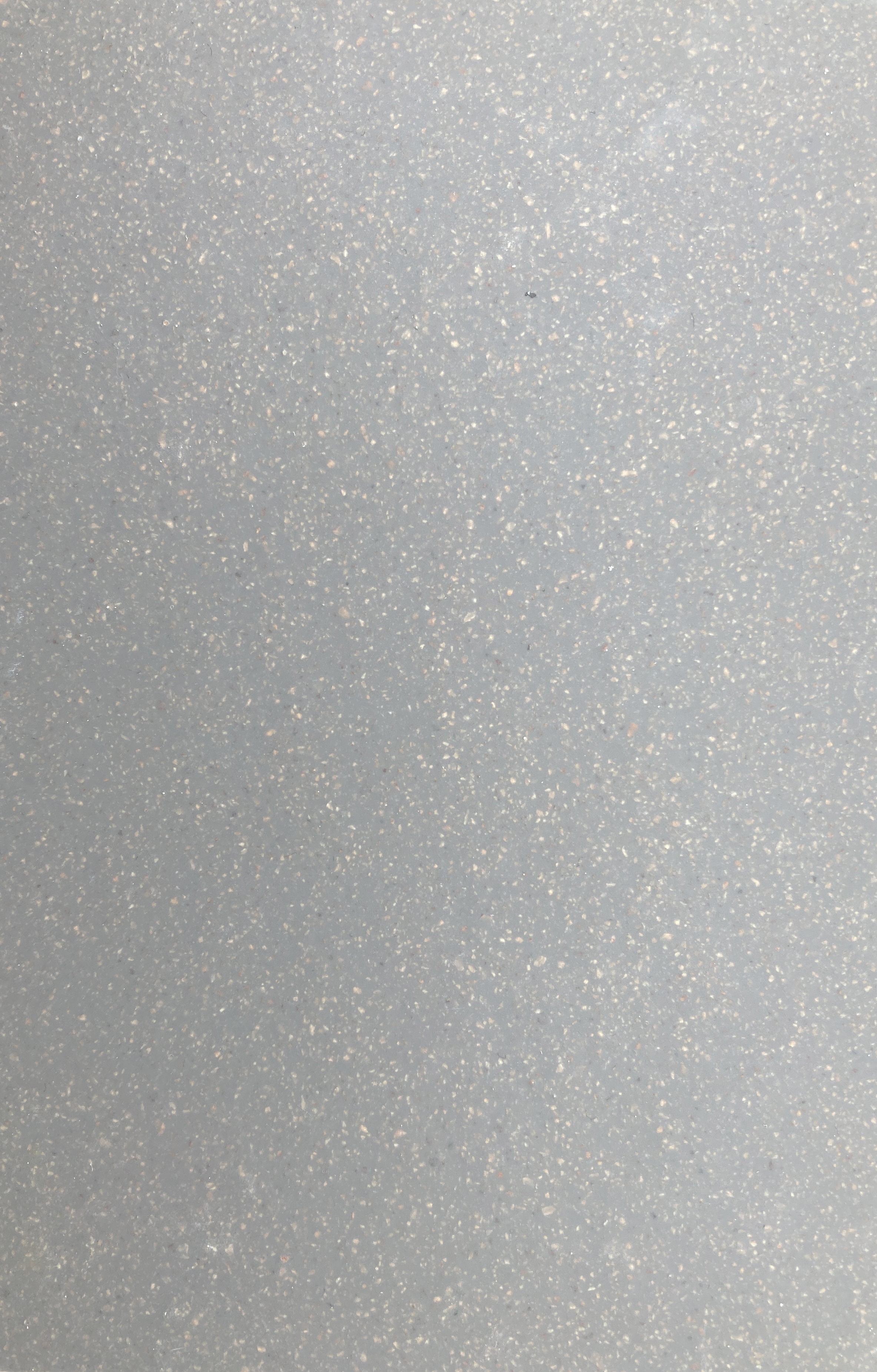 Light grey sustainable resin floor close up with light aggregate