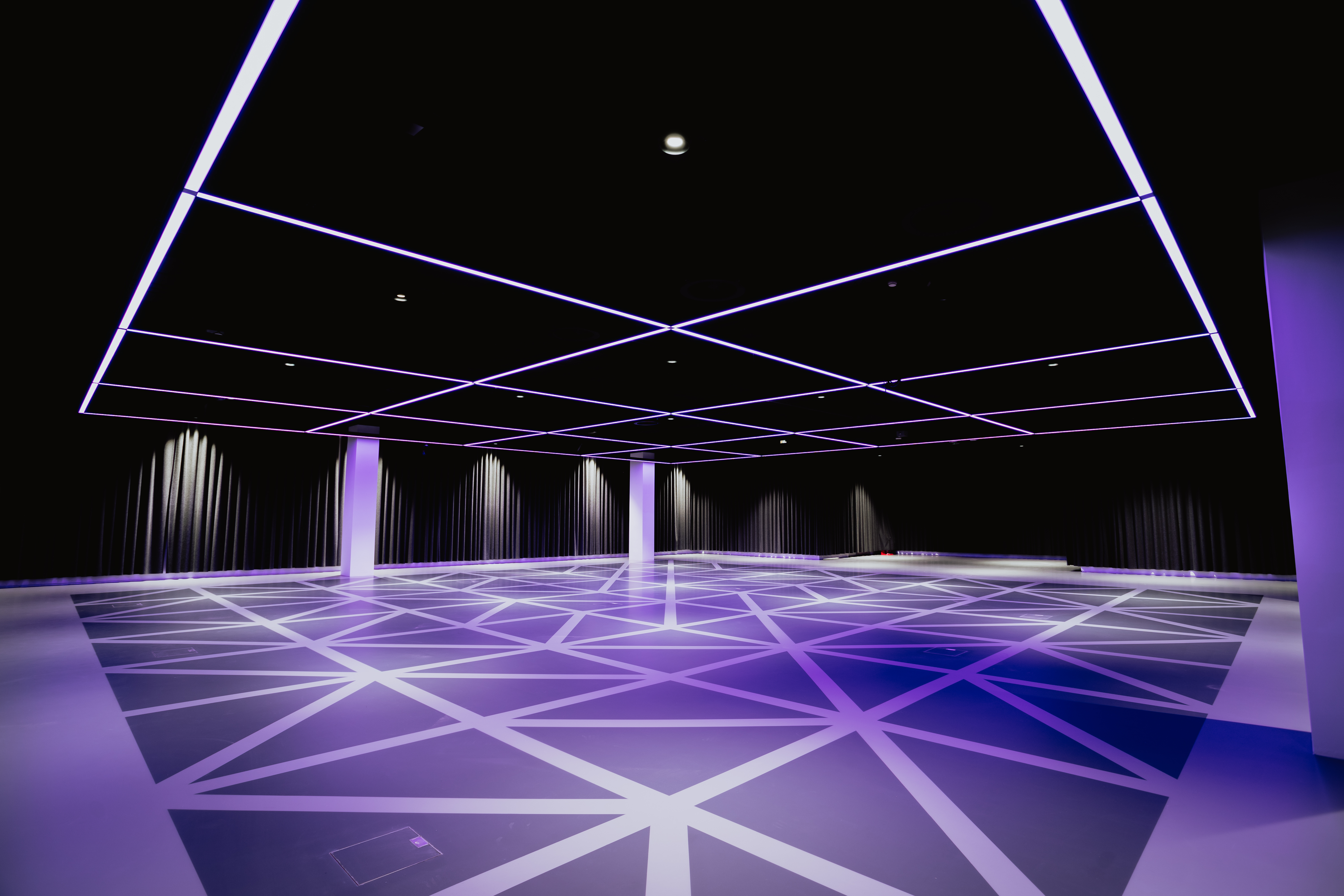 Science museum flooring with geometric design and purple lighting