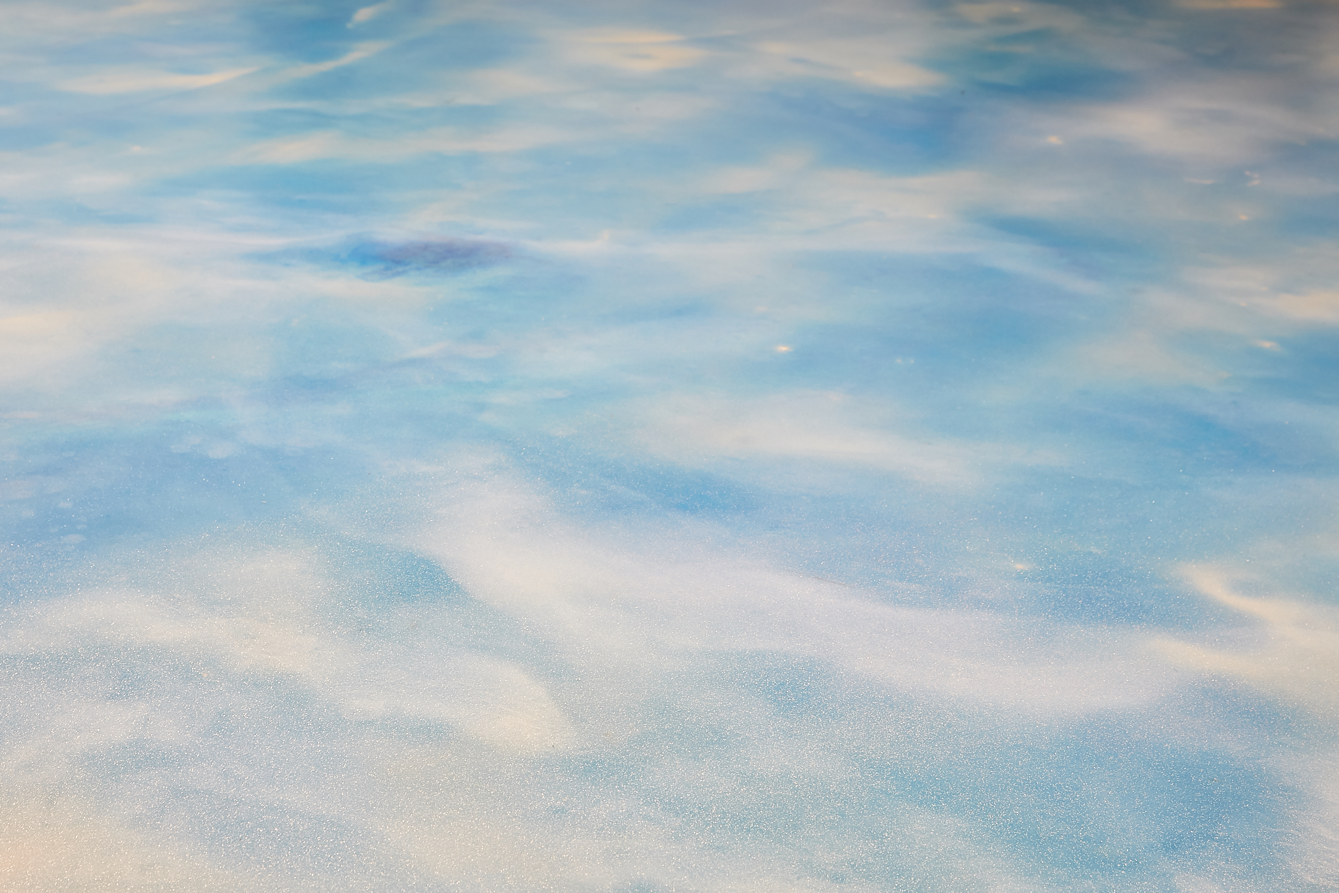 A light blue resin floor with white running through it