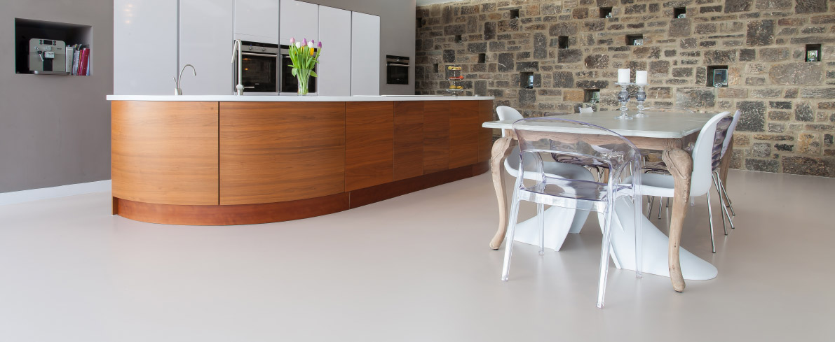 White resin kitchen flooring with light brown wood kitchen island