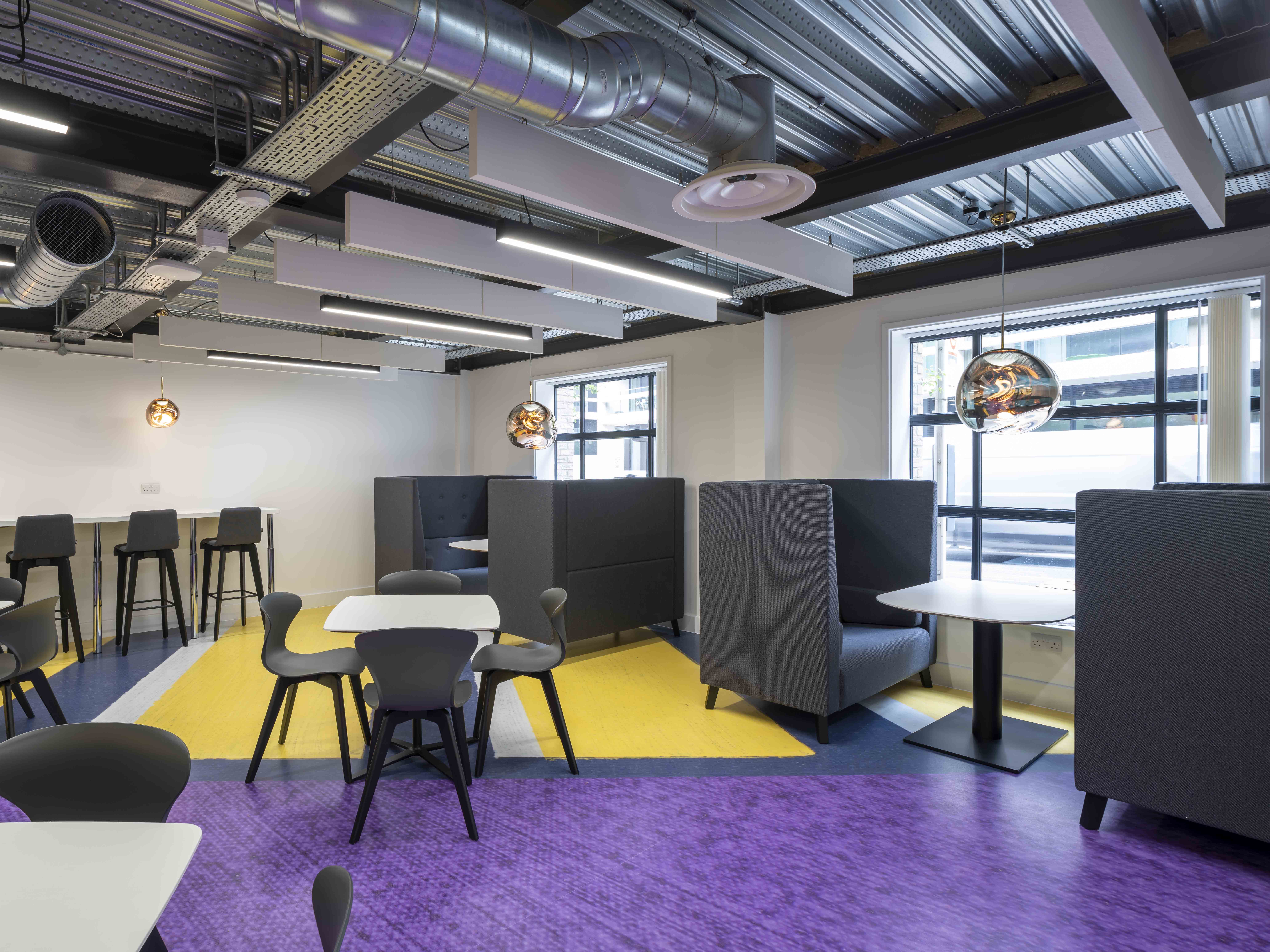 A purple and yellow designsphere floor in a seating area