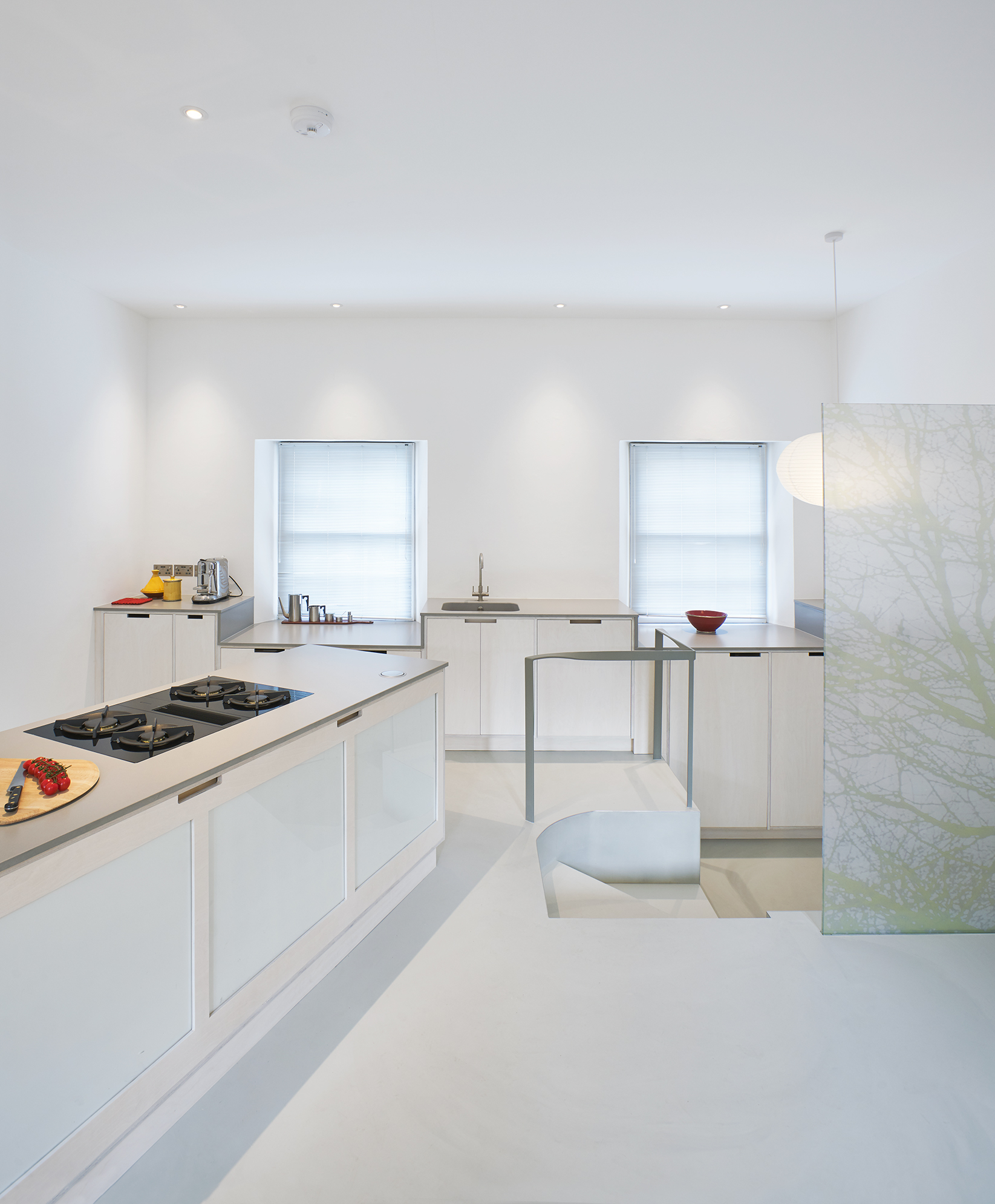 White kitchen resin floors and walls with white countertops