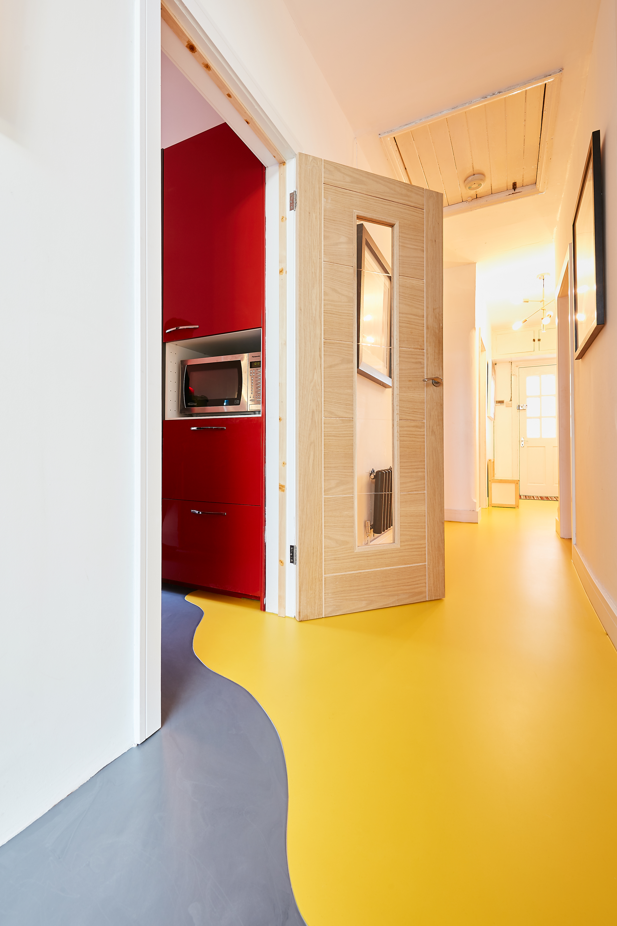 A grey and yellow resin floor in a home with a wavy split between the colours