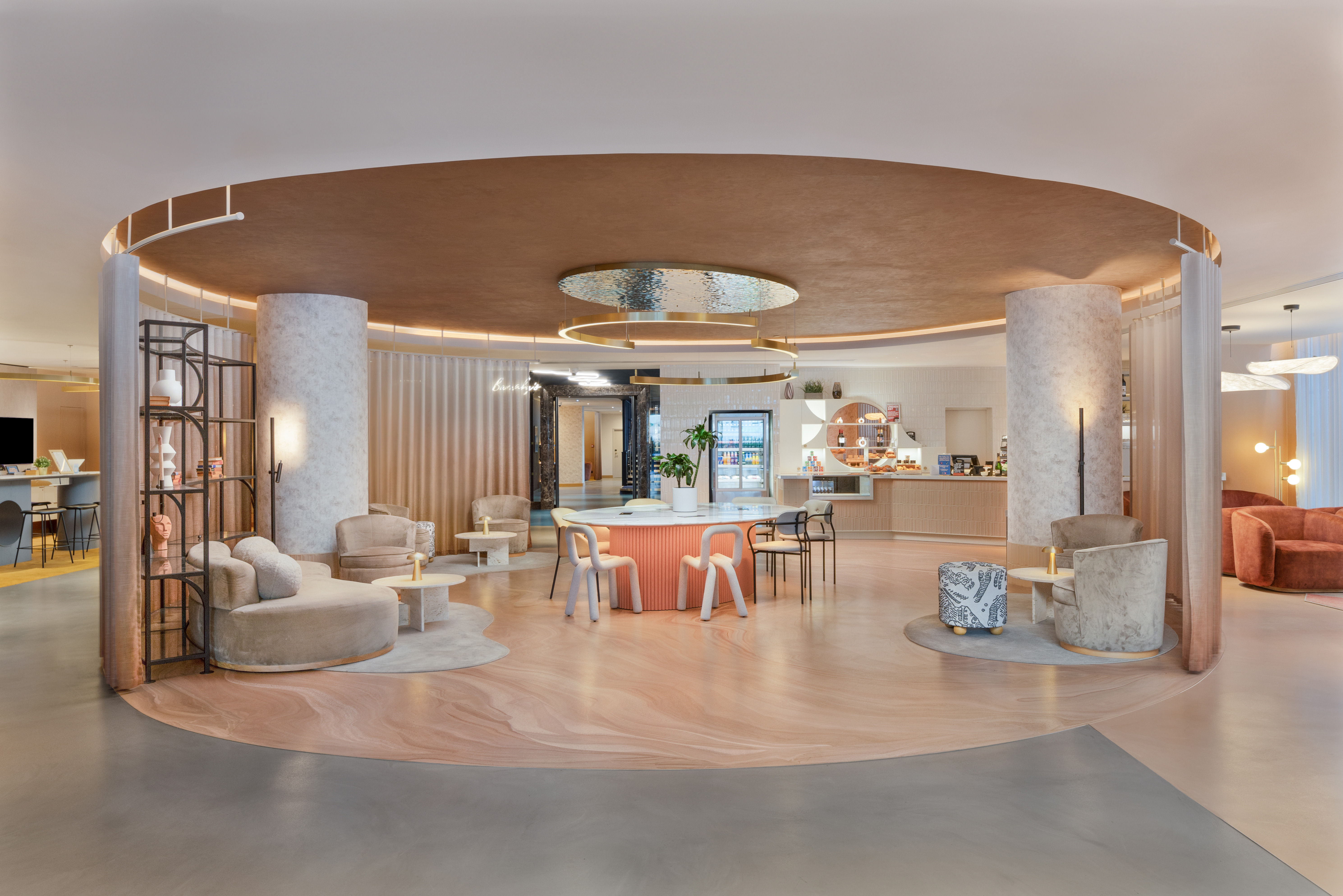 A circular hotel lobby with an inner circle of resin floor detailing lots of movement