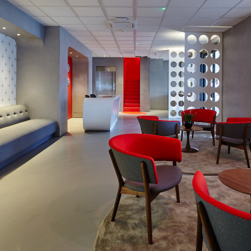 Grey commercial resin floor in an office with red furniture