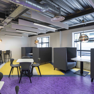 A purple and yellow designsphere floor in a seating area