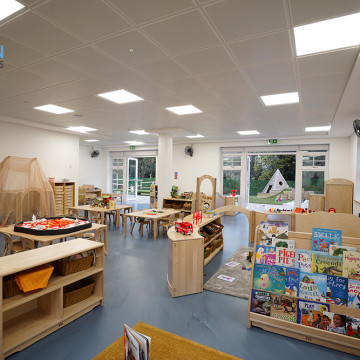 Blue resin nursery flooring with book shelves and toys