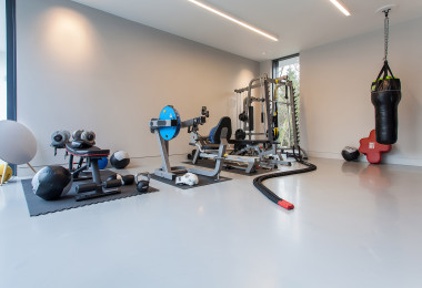 Grey residential resin floor in a home gym