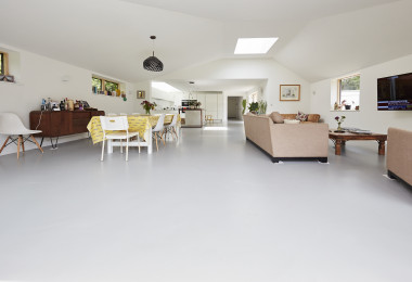 White residential resin flooring in an open plan living and dining area