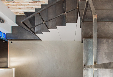 Sustainable resin flooring in a hallway with stairs