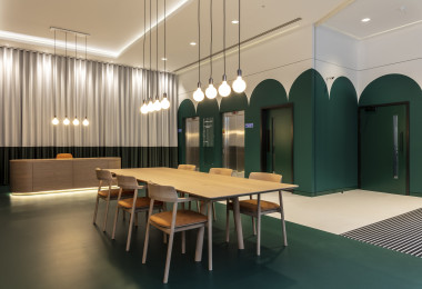 Green and white commercial resin flooring with a table and chairs in the middle of the room