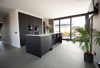 Dark grey sustainable resin flooring in a kitchen
