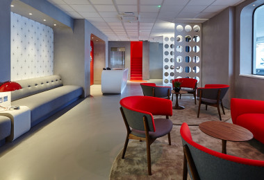 Grey commercial resin floor in an office with red furniture