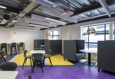 A purple and yellow designsphere floor in a seating area