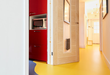 Resin flooring underfloor heating in yellow and grey in a residential space