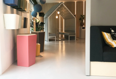 Light grey showroom resin floor with muted-toned furniture