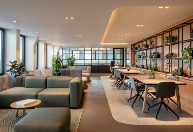 Grey commercial resin flooring in an office with sofas and tables
