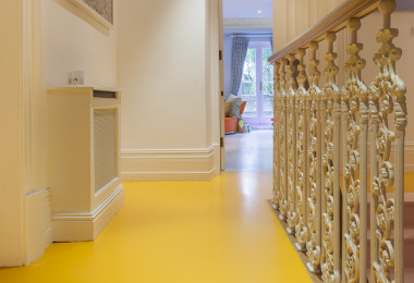 A yellow resin floor in a home hallway