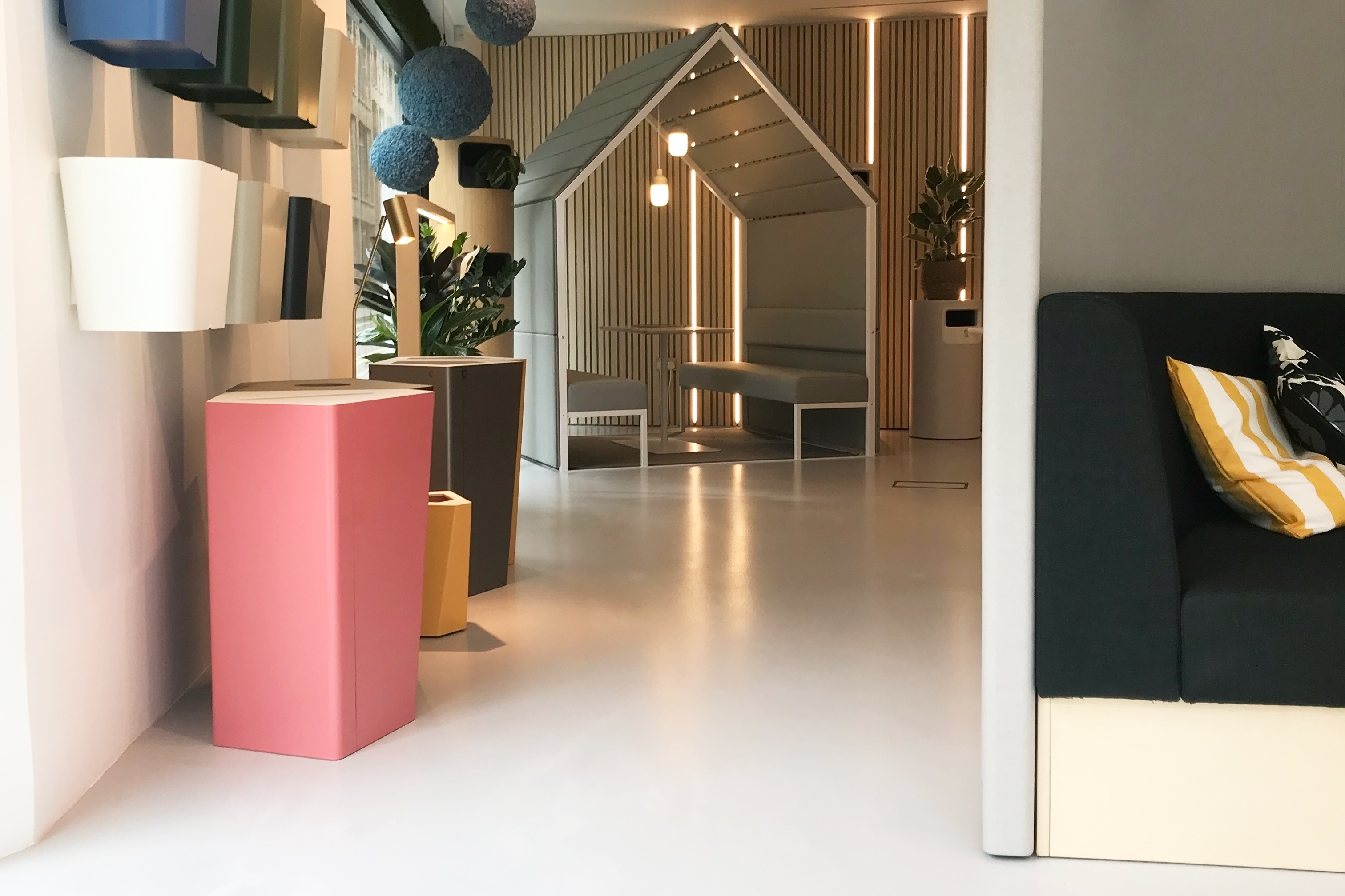Light grey showroom resin floor with muted-toned furniture