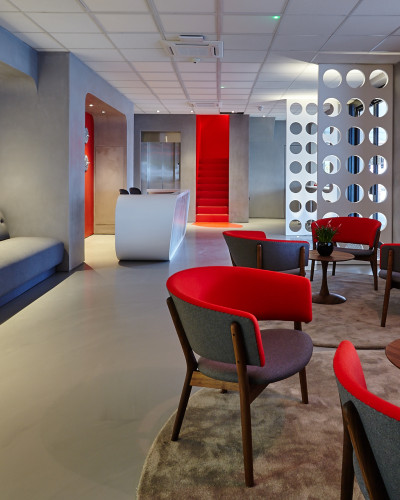 Grey commercial resin floor in an office with red furniture