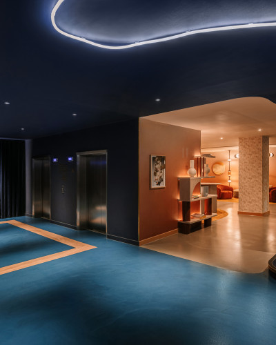 Electric blue resin floor with a rectangle beige detailing on the far left side