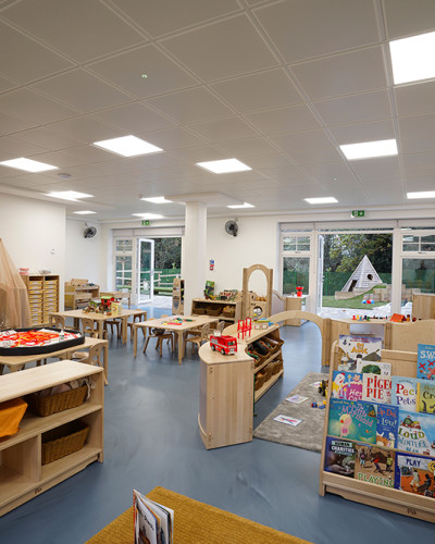 Blue resin nursery flooring with book shelves and toys